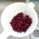 Red kidney beans are washed in running cold water