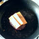 Cheese slices are laid on top of the cooked burger
