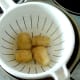 Trimmed potatoes are firstly parboiled and left to cool.