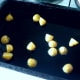 Boiled and cooled potatoes are added to hot oil for roasting