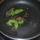 Step 8: Heat oil in a deep-bottomed pan. Add cumin seeds and curry leaves. Saute them till they sizzle.