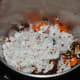 Step 2: Put boiled carrots, grated coconut, roasted spice masala, tamarind, and salt into the mixer or grinder. Grind, adding water little by little to get a near-smooth paste. Transfer it to a bowl.