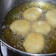 Step five: Heat oil for deep-frying. Take a lemon-sized portion of batter in your fingers and drop it into the medium-hot oil. Make 4-5 such dumplings at a time. Fry them till they are crispy and golden brown.
