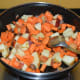 Step four: Throw in chopped carrots and apple. Add some salt. Stir-cook for 4-5 minutes.