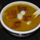Pour it equally into four bowls. Garnish with roasted bread cubes and some yogurt. Enjoy sipping it hot!