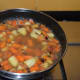 Step five: Pour about four cups of water. Increase the heat. Let the mix boil for a few minutes.