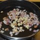 Step three: Add ginger. Continue sauteing for a minute.