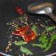 Step two: Saute mustard seeds in hot oil. Let them crackle. Add curry leaves and broken dry red chilies. Saute for a while.