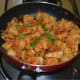 Add the chopped idlis. Toss the contents, so that the spicy masala coats the idli pieces evenly. Add the chopped coriander leaves and mix well.