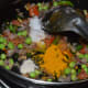 Step five: Add turmeric powder and hing powder. Stir the mix for a few seconds.
