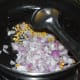 Step one: Heat oil in a deep-bottomed pan. Add mustard seeds. Once they splutter, throw in gram dal and white lentils. Saute them till they become golden brown. Add onions.
