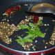 Step two: Heat oil in a deep-bottomed pan. Throw in remaining cumin seeds, white lentils, broken red chilies, carom seeds, hing powder, and curry leaves. Saute till lentils turn golden brown.