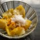 Step two: Take them out. Chop each of them in four equal parts. Remove the seeds. Discard them. Mix the lemons with salt and turmeric powder. Set aside for 5-10 minutes.