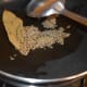 Step 4: Heat oil in a deep-bottomed pan. Saute bay leaf and cumin seeds as per instructions.