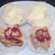 Ketchup is added to sausages on rolls