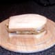 Assembled chicken schnitzel and crisps sandwich