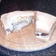 Cod, tzatziki sauce and crisps sandwich is cut to serve