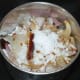 Step six: Put all the sauteed ingredients except fenugreek leaves into a mixer or blender. Add grated coconut and salt. Grind together to get a coarse paste. No need to add water while grinding.