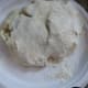 Take the dough ball out and coat both sides with flour.