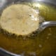 Step seven: Gently slide it into the hot oil. Keep the heat medium-high in the beginning.
