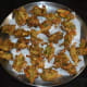 Step five: Reduce the heat. Fry till they are crispy and golden brown. Take them out with the help of a slotted ladle. Place them on an absorbent paper towel.