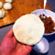 Flatten each dough ball before putting the jam.