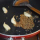 Step one: Heat a teaspoon of oil in a deep-bottomed pan. Saute the garlic cloves in it till they become golden brown. Add cumin seeds. Let them sizzle.