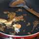 Sizzling the cumin seeds.