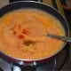Step seven: Transfer it to the same pan. Add 2-3 cups of water. Add red chili powder and garam masala powder. Bring the mixture to a gentle boil, simmer for twenty seconds.
