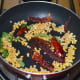 Step one: Saute lentils, curry leaves, and broken dry red chilies in oil as per instructions