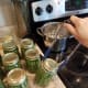 With your jar lifter, move finished jars to your canner. Fill the canner with only 3 quarts of water.