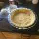 Roll out the larger part of the dough and cover the bottom of the pie pan.
