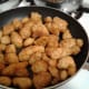 Place chicken nuggets (already cooked) in heated oil