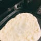 Flip the bread once it forms some bubbles.