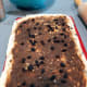 Brush melted butter on the dough, sprinkle ground cinnamon and brown sugar. Add more raisins if desired.