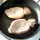 Pork fillets are turned to fry on their second sides