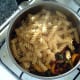 Cooked and drained pasta is added to sauce