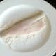 Sea bass is lightly floured on skin side for frying