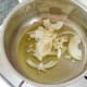 Onion and garlic are added to small saucepan
