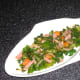 Sauteed kale and bacon is plated