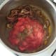 Tomatoes are added to softened spiced onion