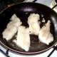 Whiting fillets are turned in the pan