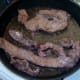 Liver is turned to fry on second side