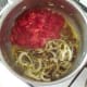 Tomatoes and chilli are added to sauteed onion