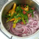 Peppers are added to softened onion