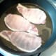 Bacon is added to hot frying pan