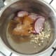 Onion, garlic, seasonings and spices are added to a saucepan