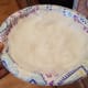 Start with your crust first so it can cook while you're making the filling. The trick to this recipe is making your coconut oil ice cold. I smear mine on a plate into a thin even layer and pop it into the freezer.