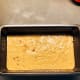 Pour the batter into the prepared baking pan.