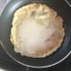 The pan should be very hot before swirling in just enough batter to coat the base.
